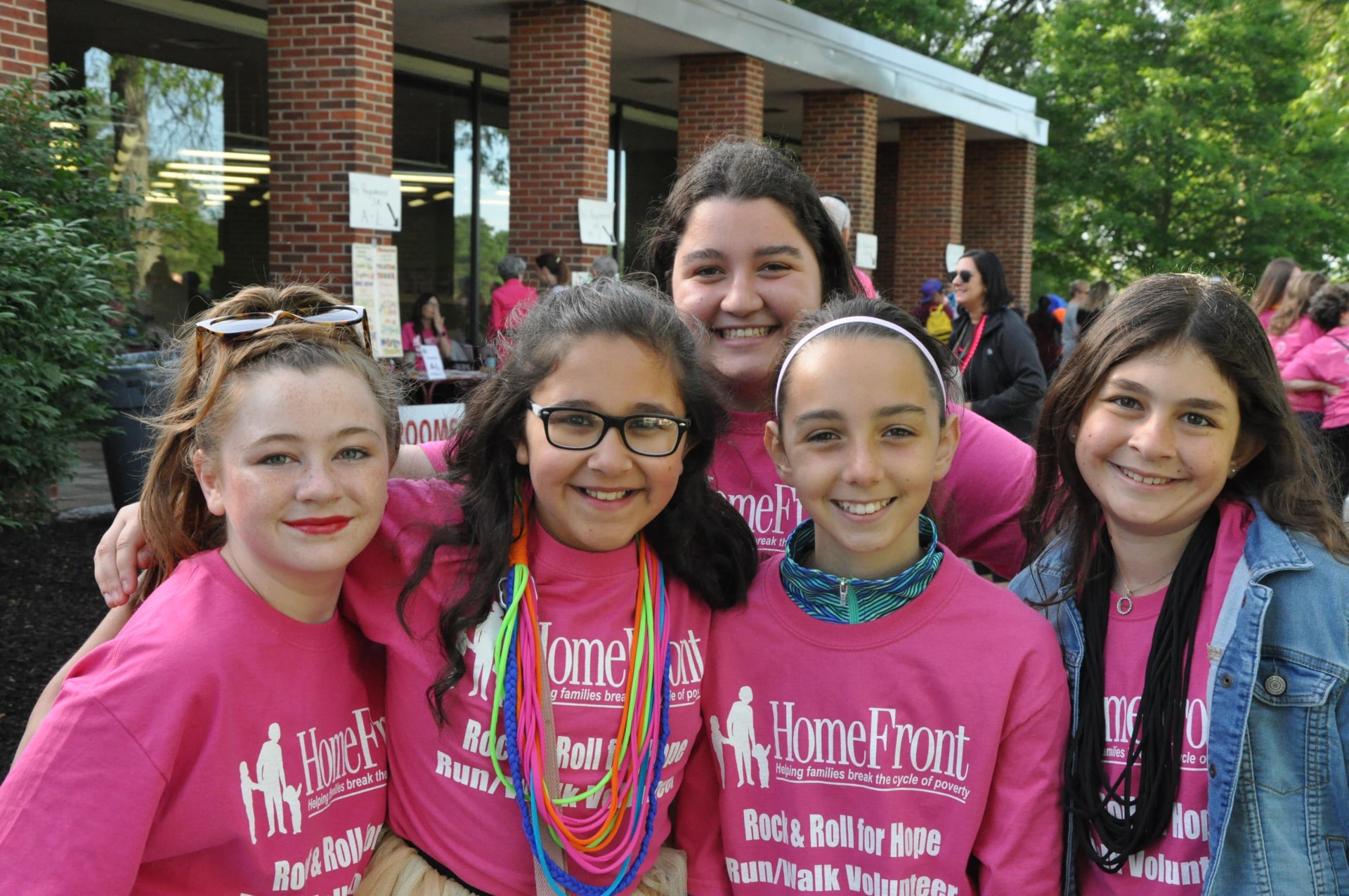 a group of childs wearing pink shirts