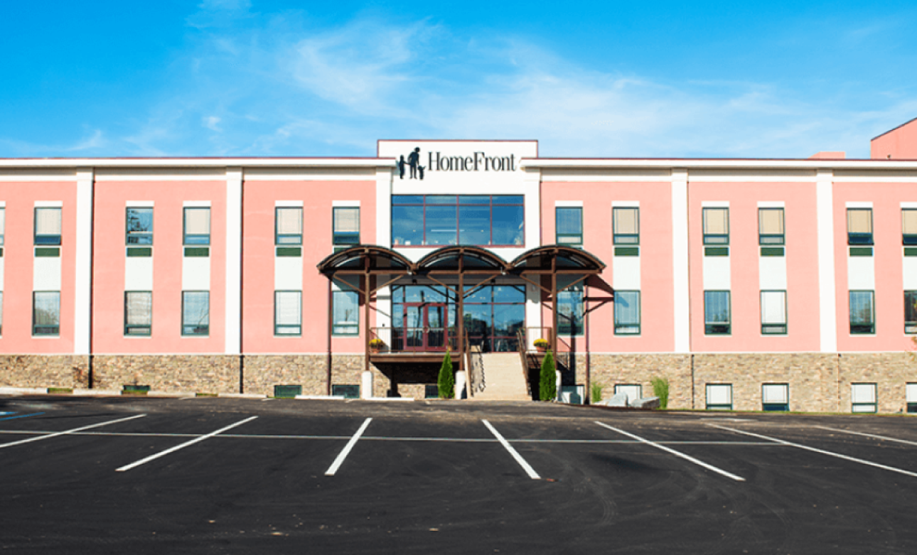 a pink building with a parking lot