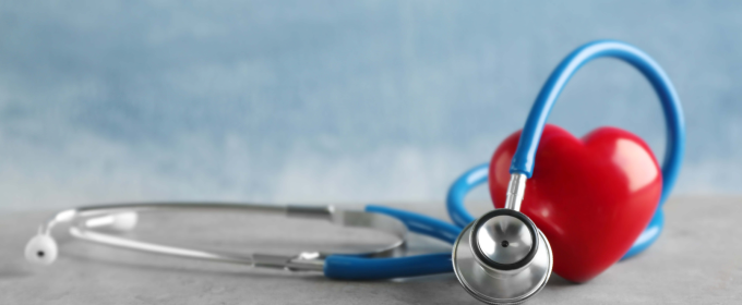 a heart and a stethoscope on a table