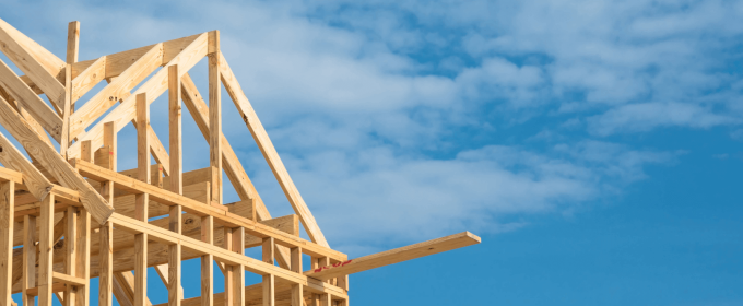 a house under construction with a blue sky in the background