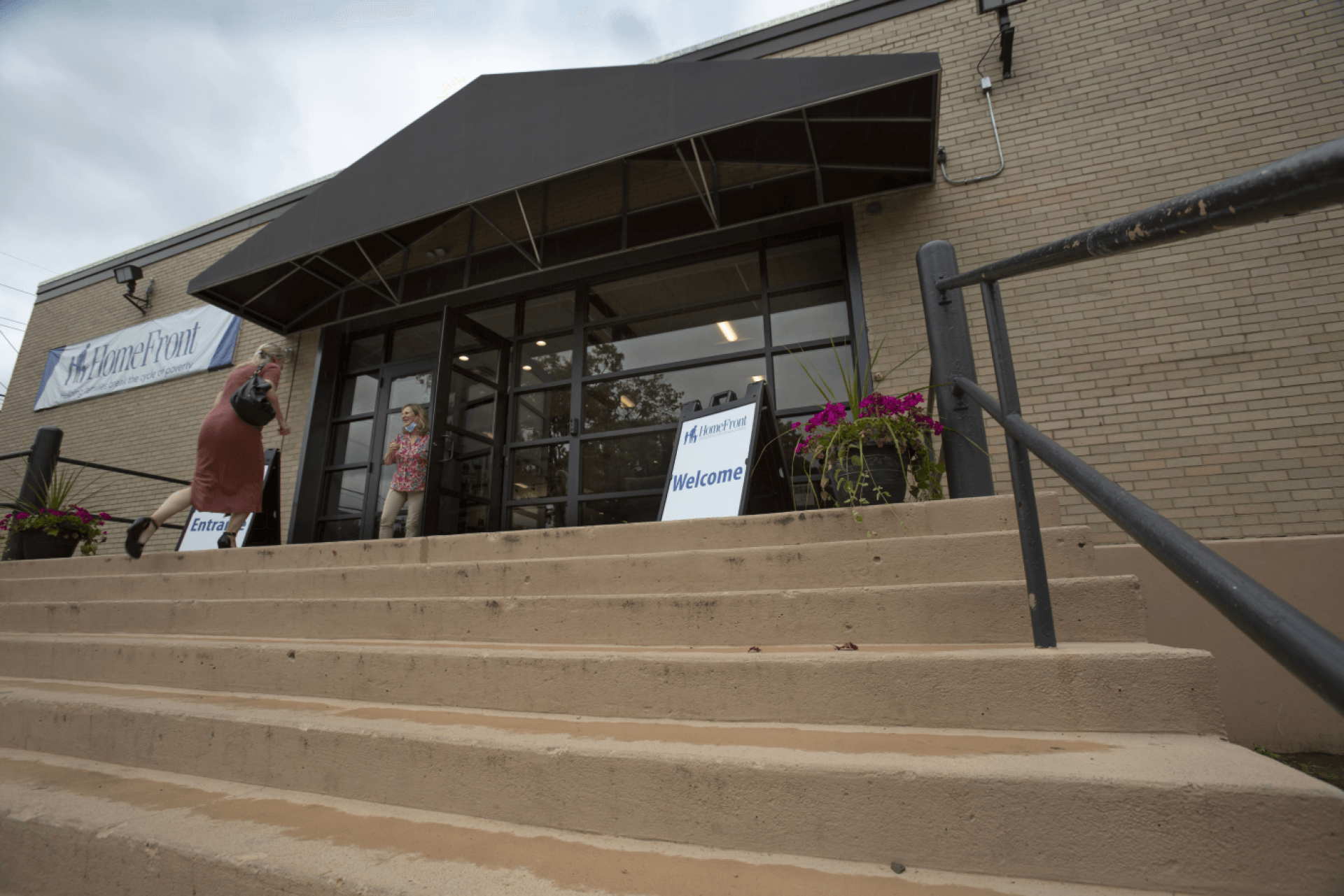 a building with stairs and a sign