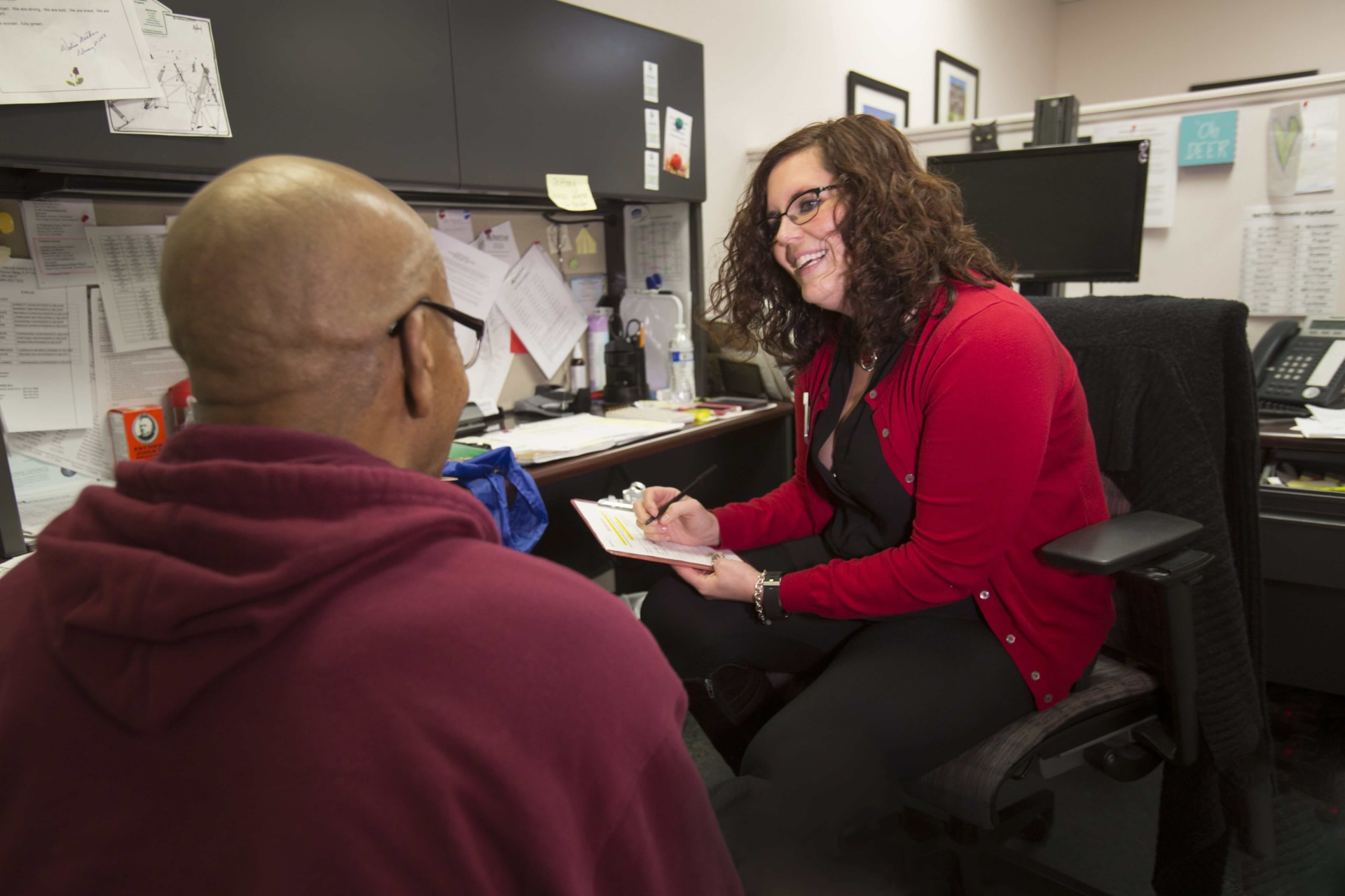 a person sitting in an office with a person in a chair