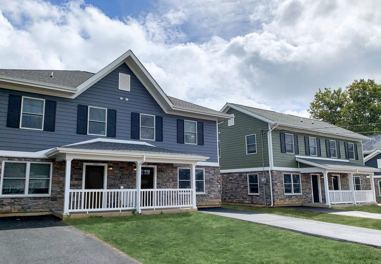 a row of houses with a white railing