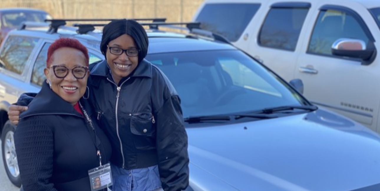 a person standing in front of a car